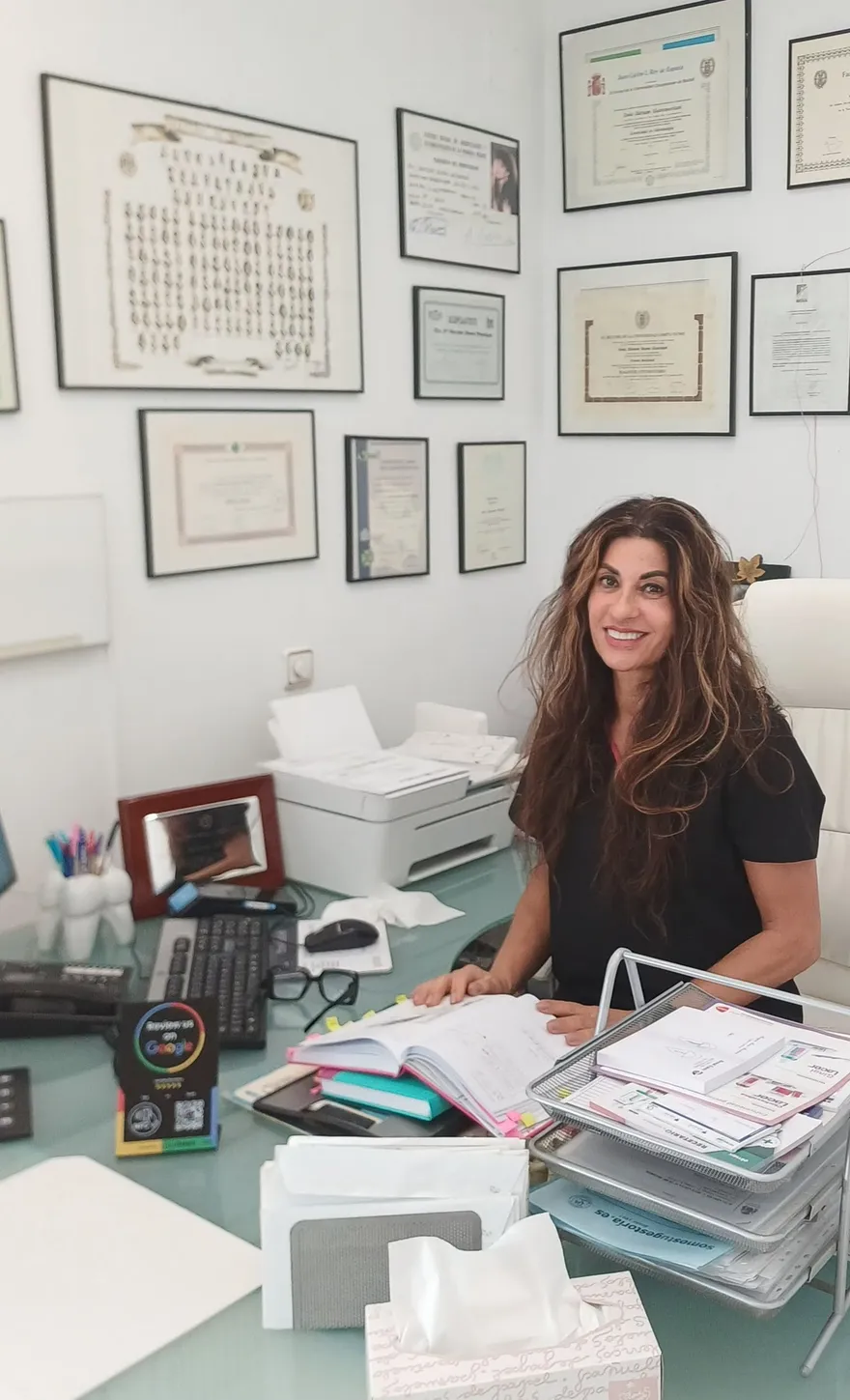 Dra. Maryam en su despacho con titulaciones colegiales